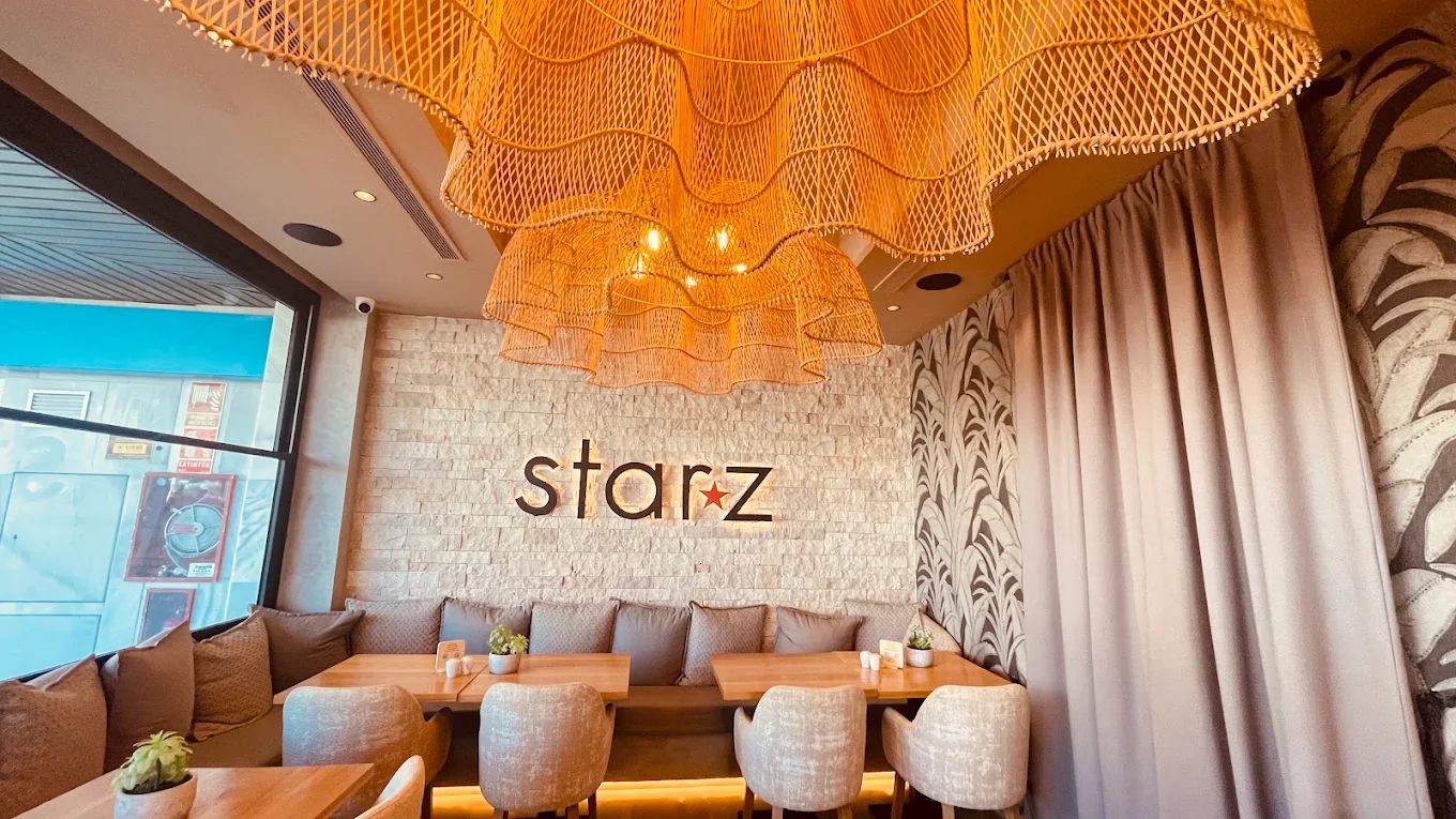 The refurbished Starz dining room with woven rattan pendant lights above the banquette